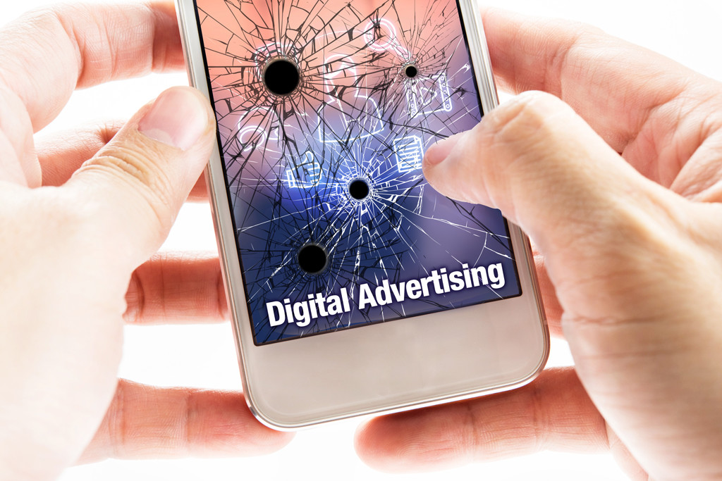 person holding a shattered smartphone in their hands