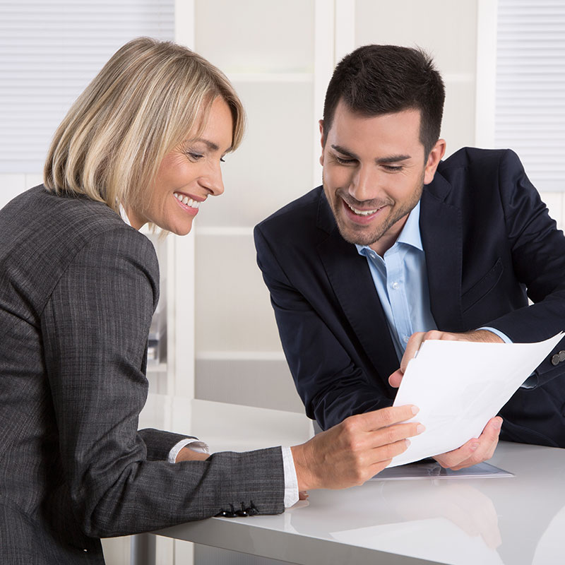 Picture of a man and woman going over a document together.