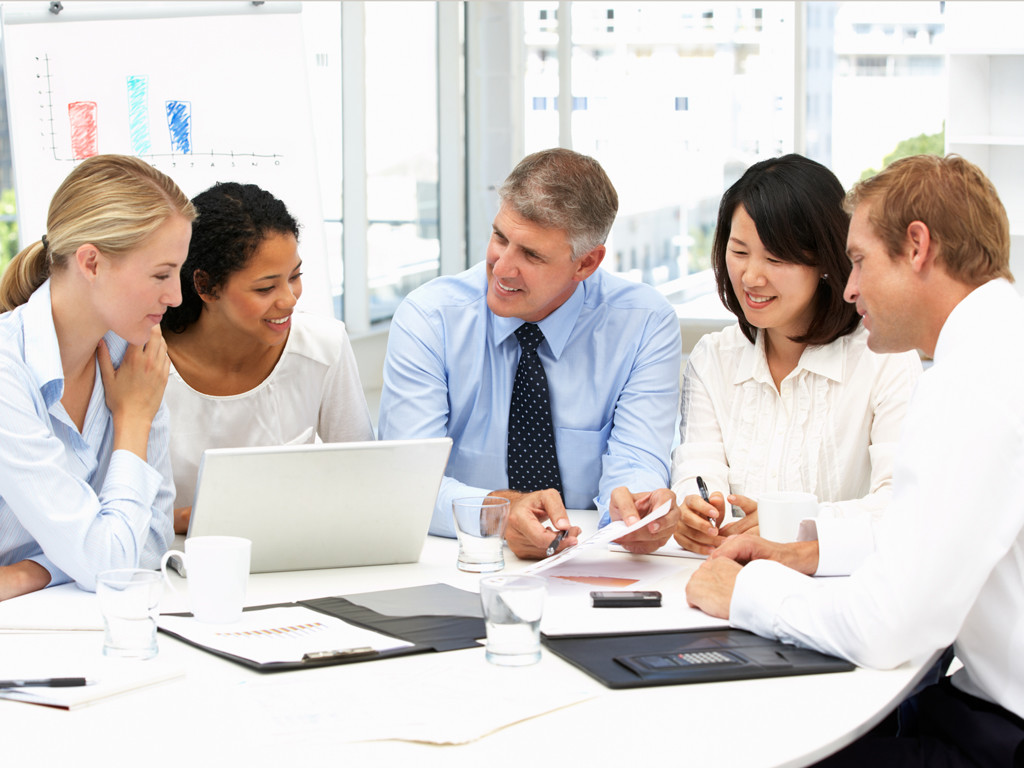 photo of office meeting between the owner of the business and the media agency team working on his account