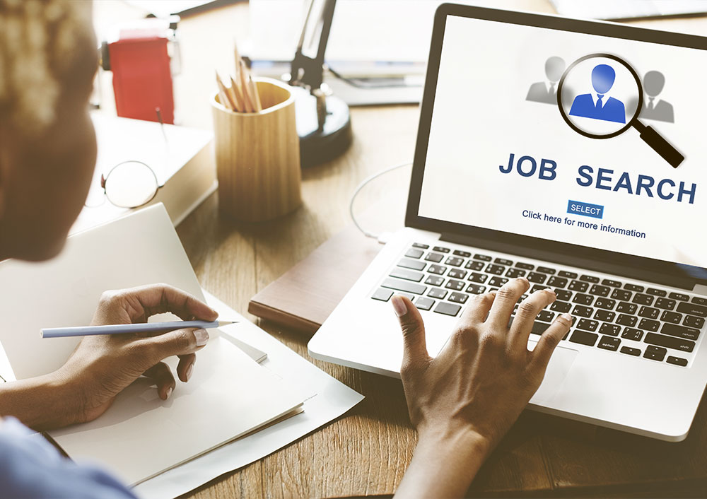 online-job-search person looking for a job online using their laptop