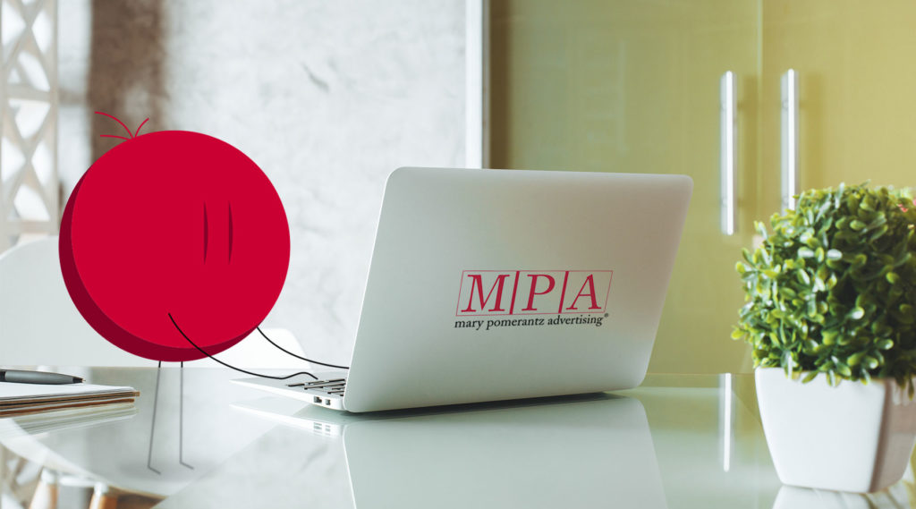 photo of a laptop with the letters MPA on the back and employee icon symbol typing on it